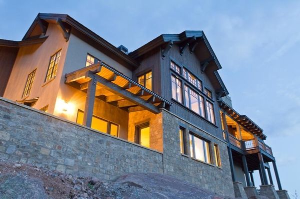 A large house with a lot of windows is lit up at night
