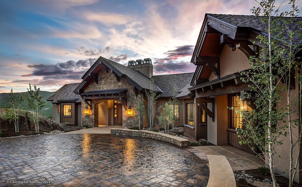 A large house with a pond in front of it.
