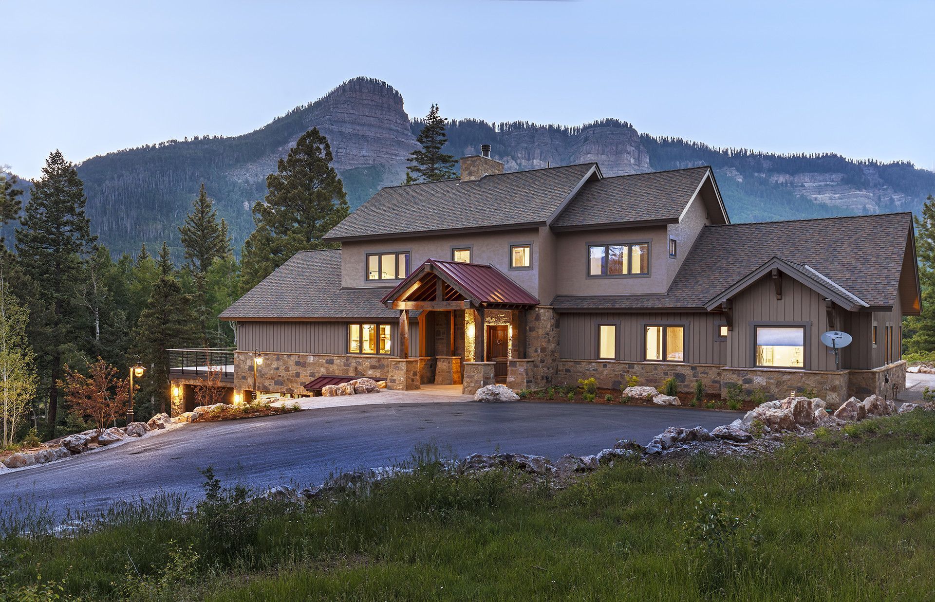 A large house with a mountain in the background