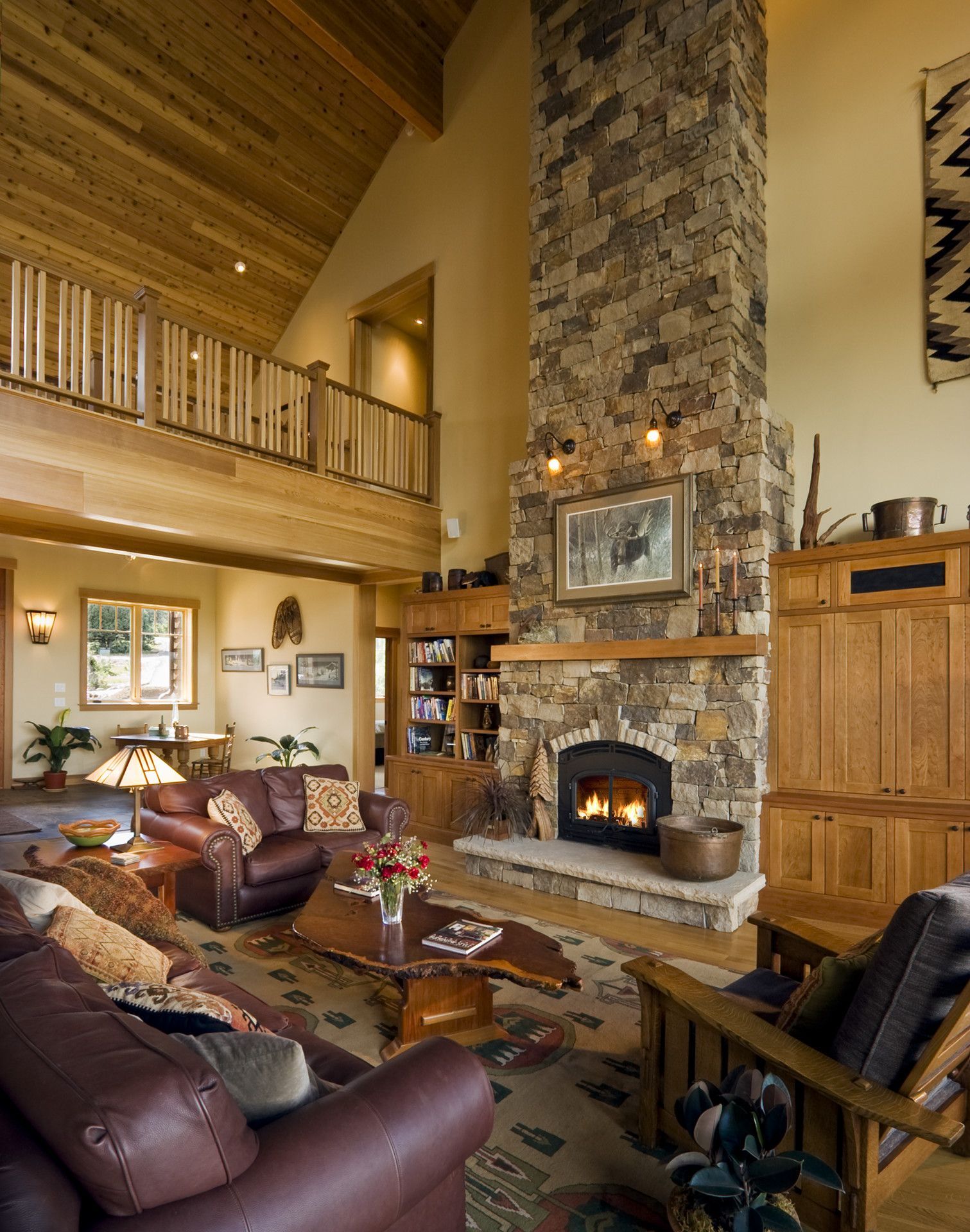 A living room with a large stone fireplace