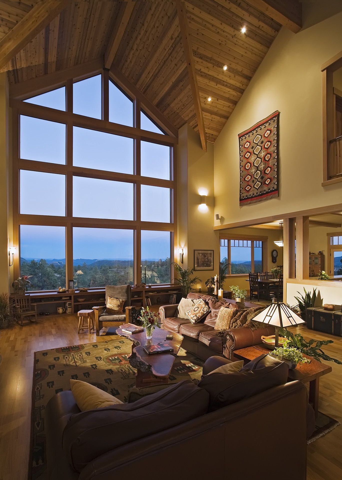 A living room with a vaulted ceiling and lots of windows