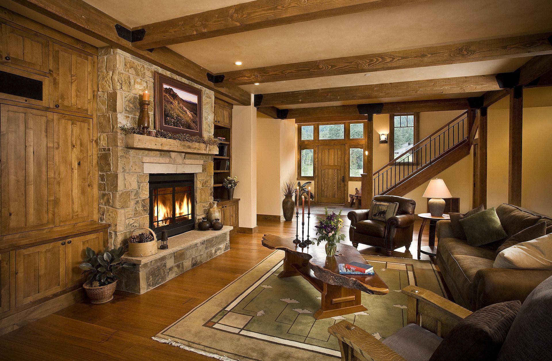 A living room with a fireplace and wooden beams