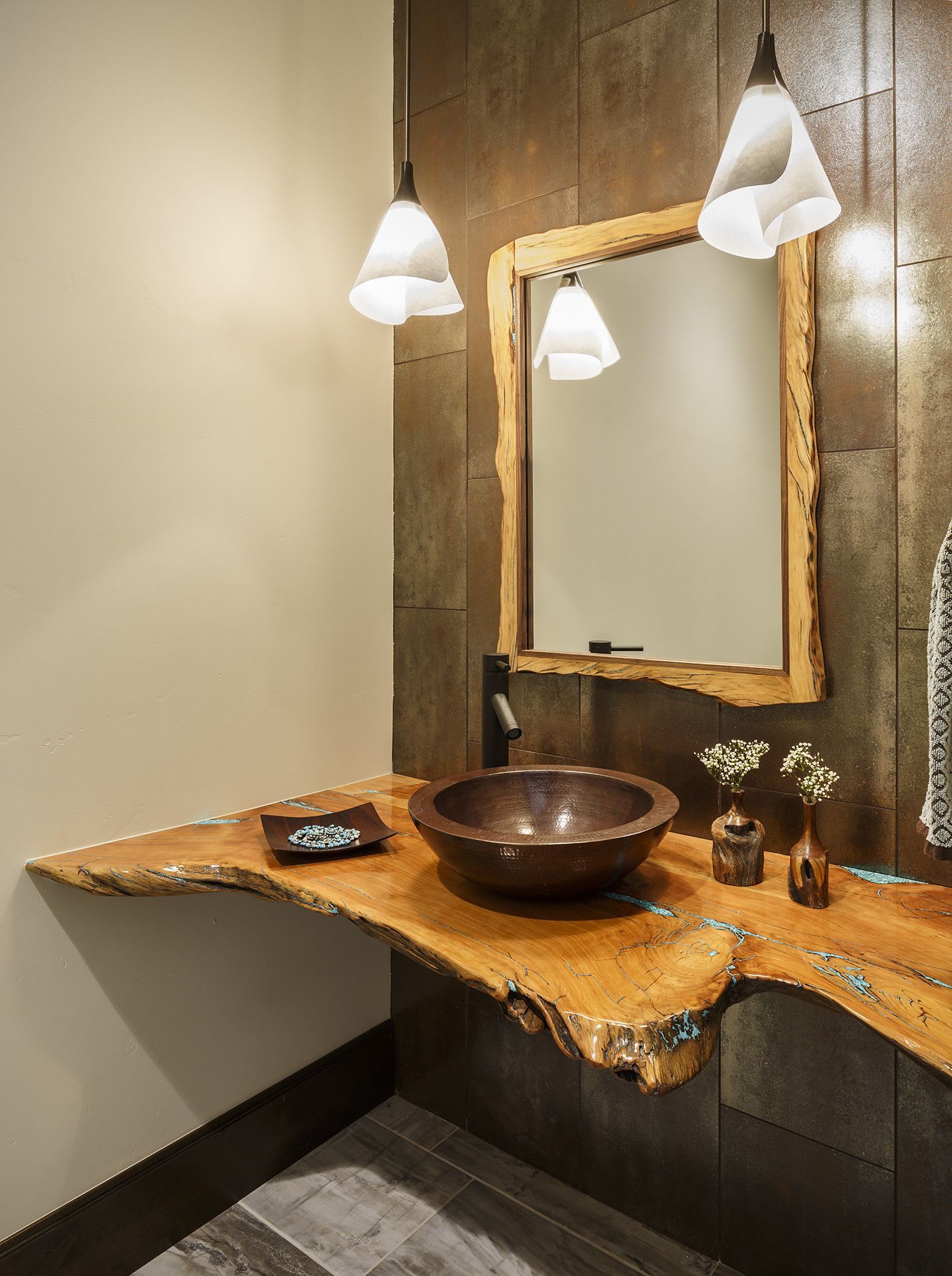 A bathroom with a sink , mirror and wooden counter top