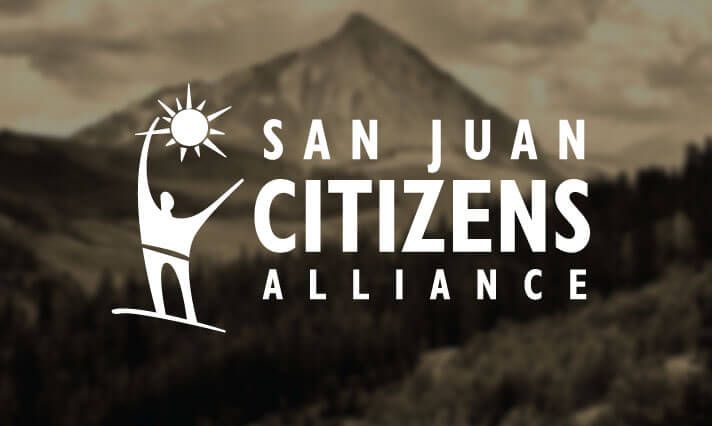 A logo for san juan citizens alliance with a mountain in the background