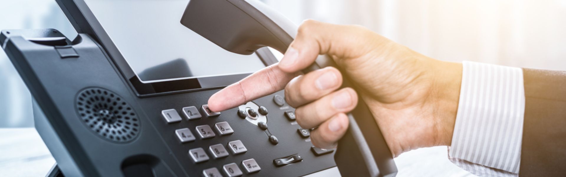 A smartphone showing a VoIP app with internet and communication icons around it.