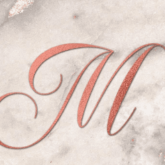 a close up of the letter m on a marble background