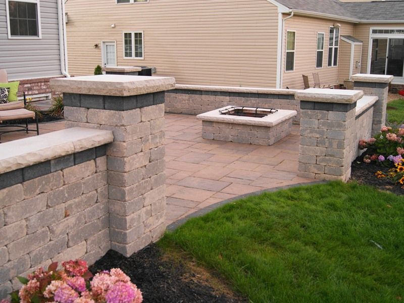 Patio with brick walls, fire pit, and landscaping.