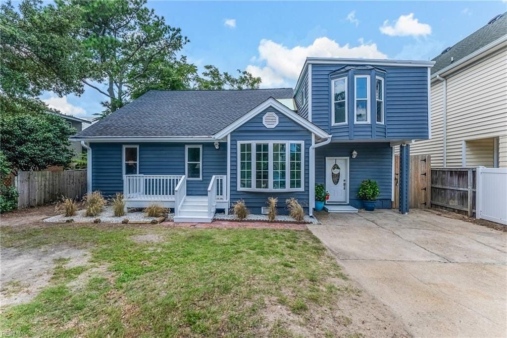 A blue house with white trim and a lot of windows