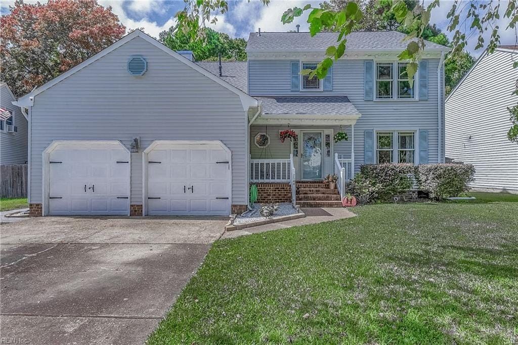 A white house with blue shutters and a large driveway.