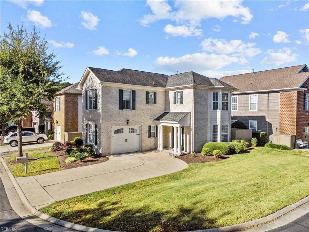 A large house with a large lawn in front of it is for sale.