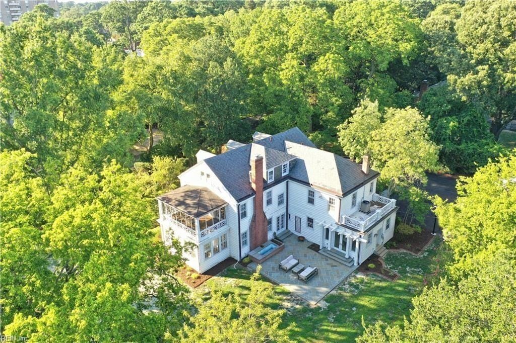 An aerial view of a large house surrounded by trees.