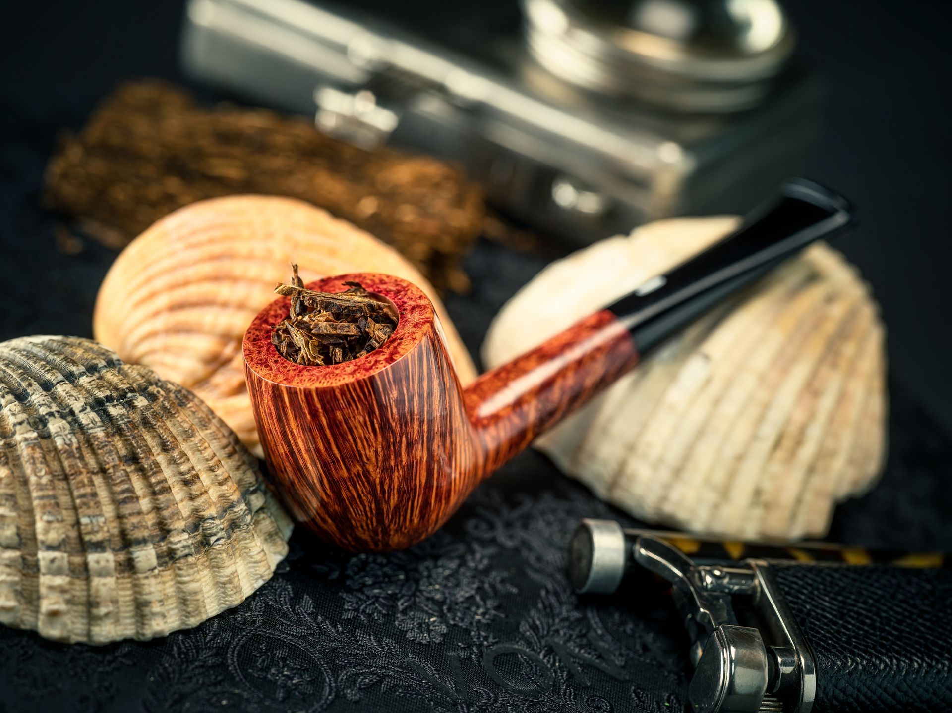 A man in a suit and tie is holding a tray of cigars