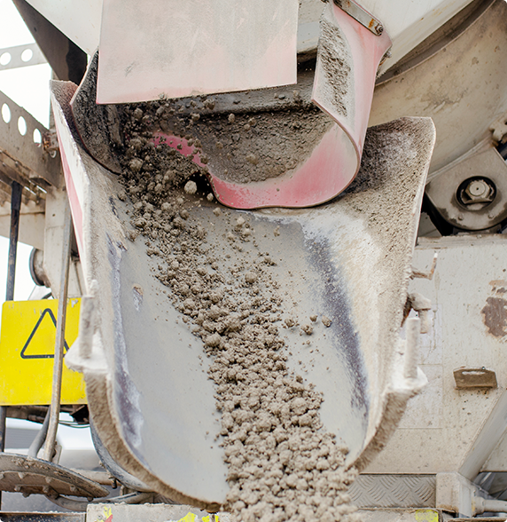 A concrete mixer is pouring concrete into a bucket