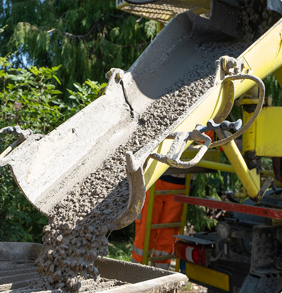 A concrete truck is pouring concrete into a bucket