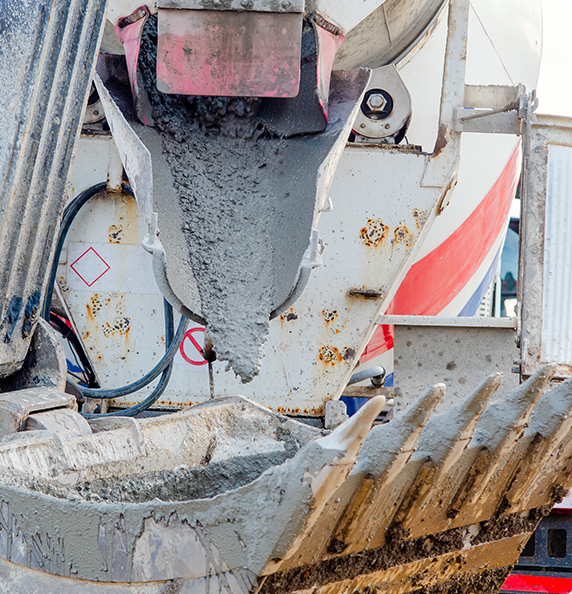 A concrete mixer is pouring concrete into a bucket