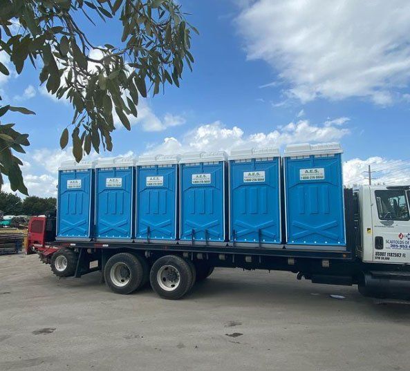 Blue Portable Toilets in the Truck — Miami, FL — A.E.S. Portable Sanitation, Inc.