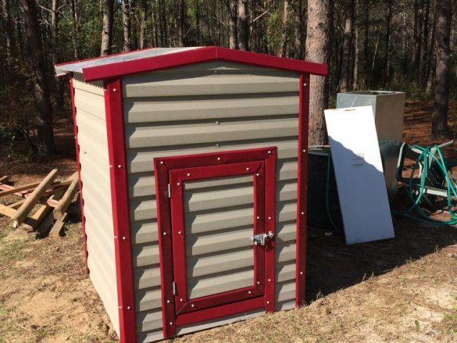 Tan & red portable storage shed in Panama City, FL