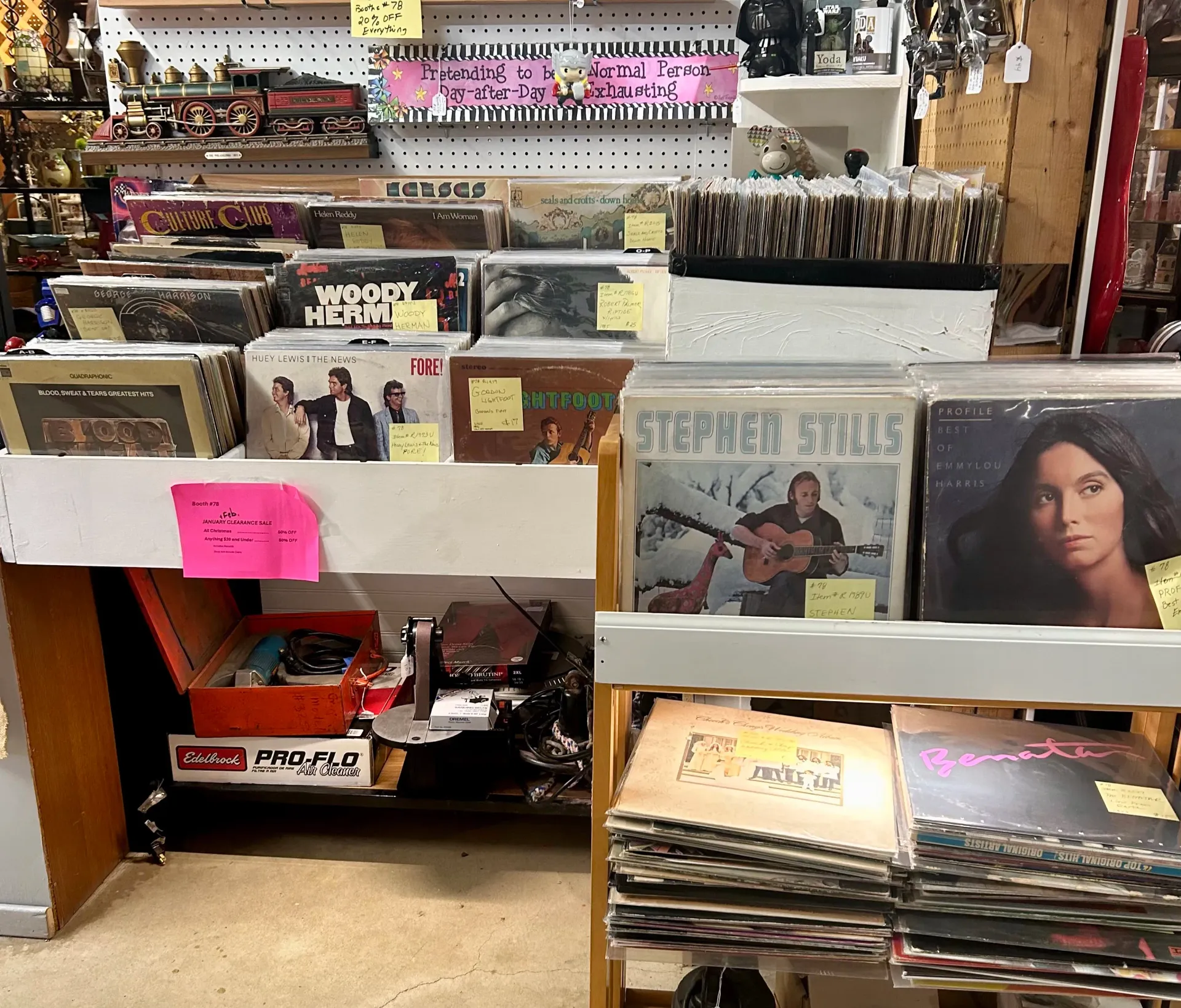 Vinyl records organized on shelves and in bins in a retail store, with various album covers visible.