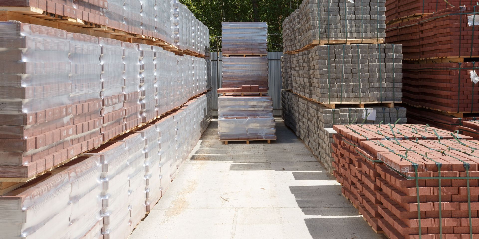 A lot of bricks are stacked on top of each other in a warehouse.