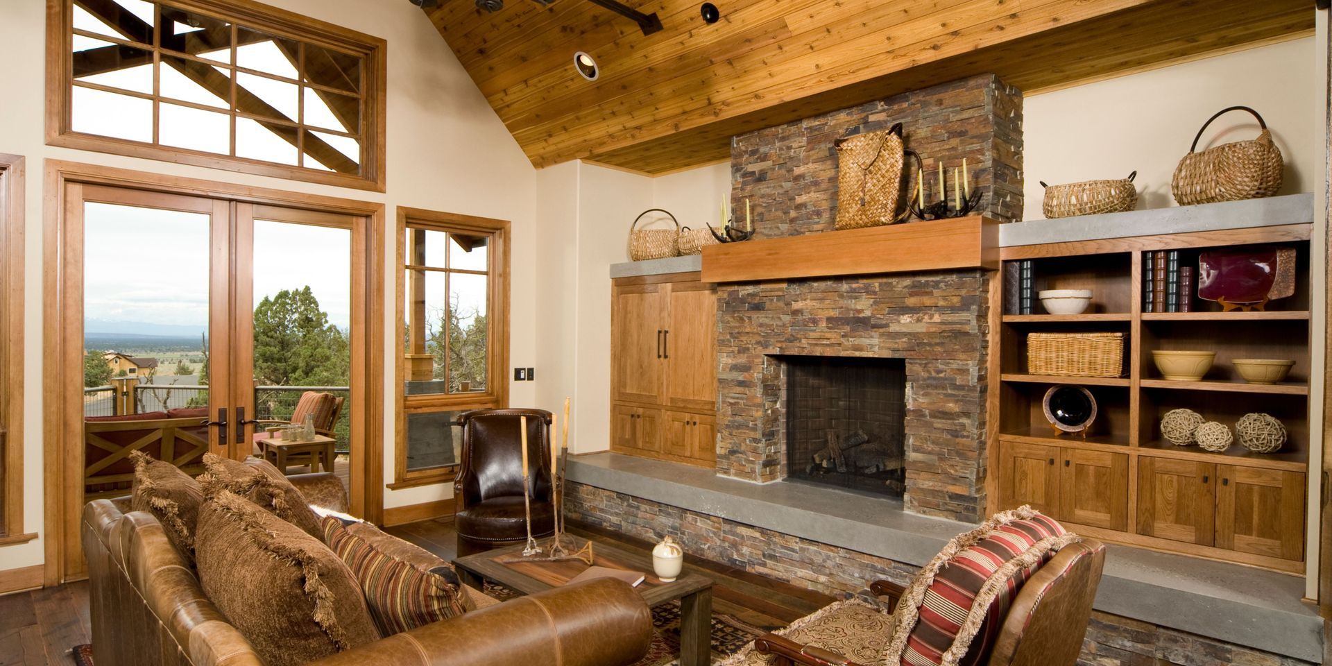 A living room with a stone fireplace and a couch