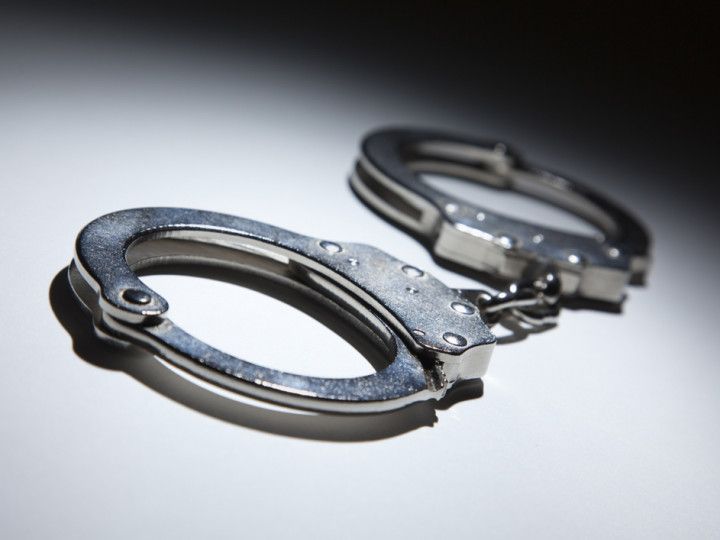 A pair of handcuffs on a white surface
