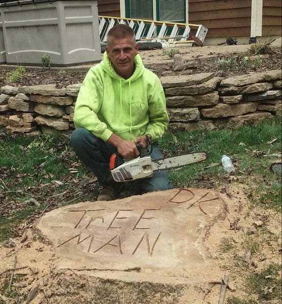Man kneeling, carving 