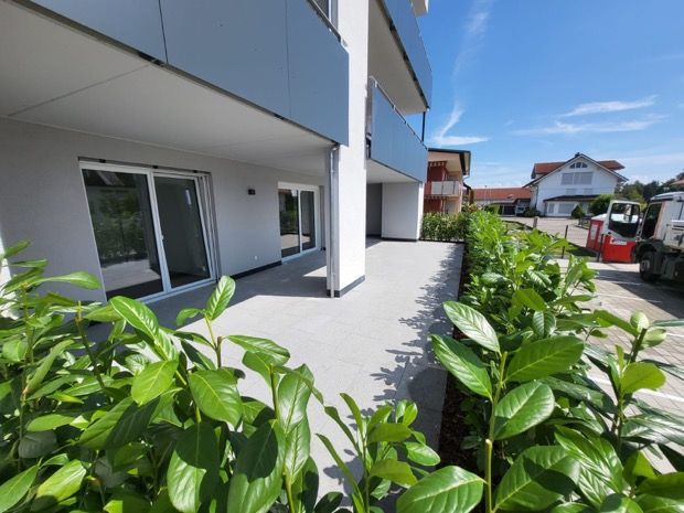 Vor einem im Bau befindlichen Gebäude liegt ein großer Erdhaufen.