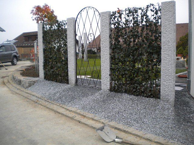 Ein Zaun mit einem Tor und einer Schaufel davor