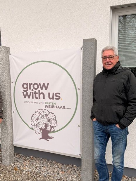 Ein Mann sitzt an einem Schreibtisch vor einem Computer.