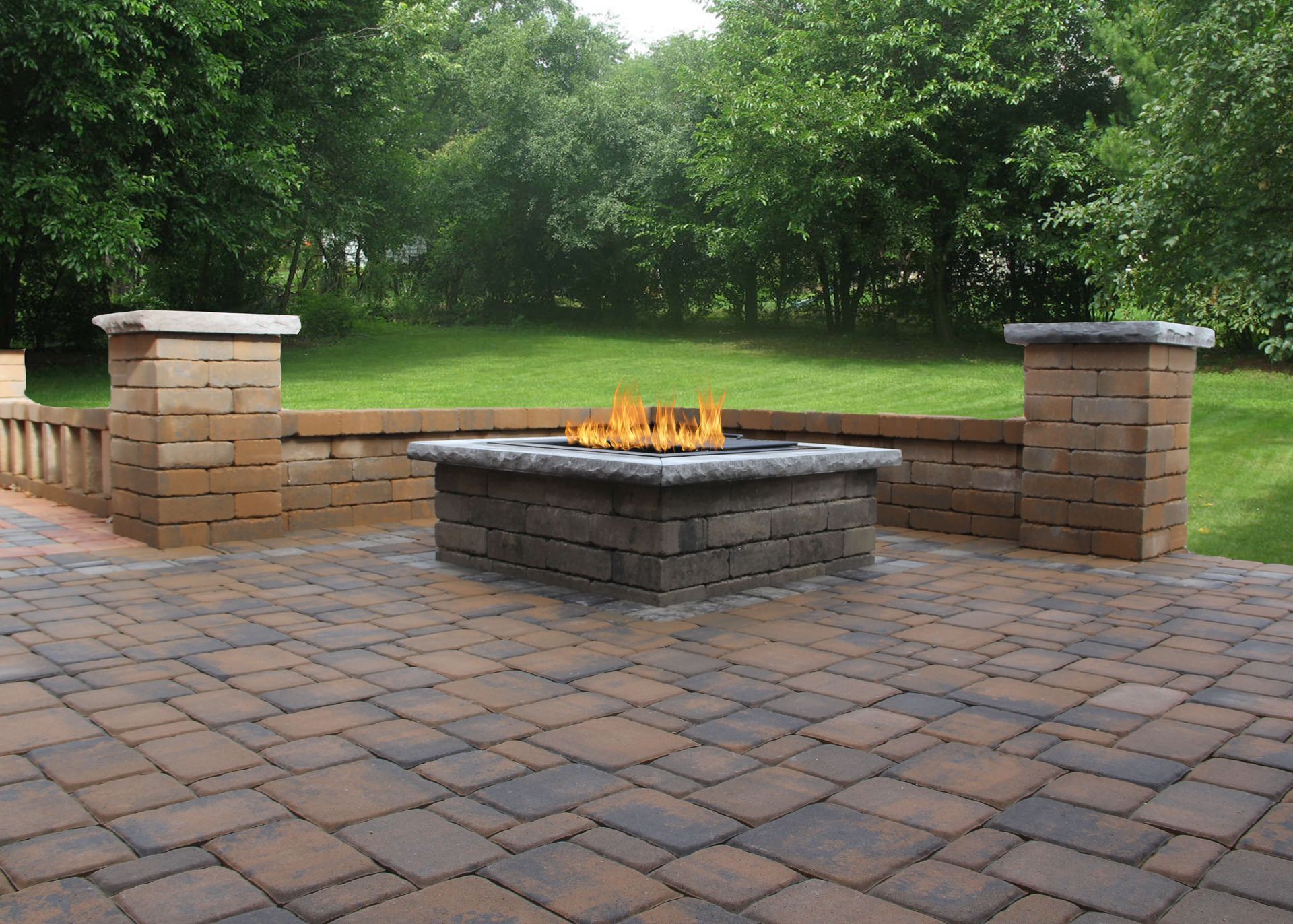 A fire pit is sitting on a brick patio