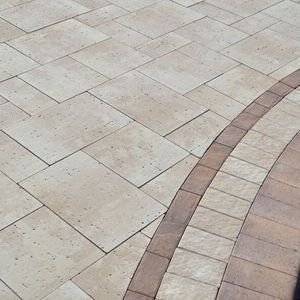 A close up of a brick walkway with a brick border.
