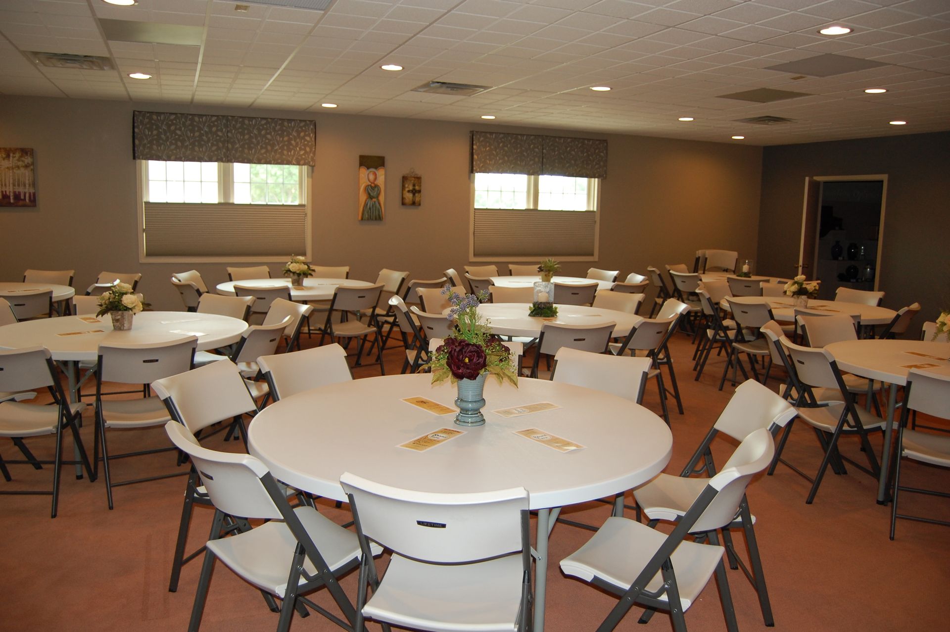 A large room with tables and chairs set up for a party