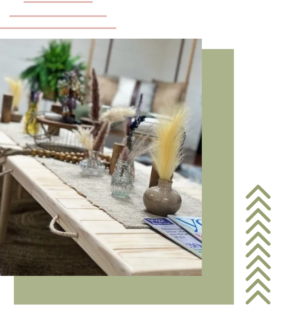 a wooden table with vases and feathers on it | party planning ideas
