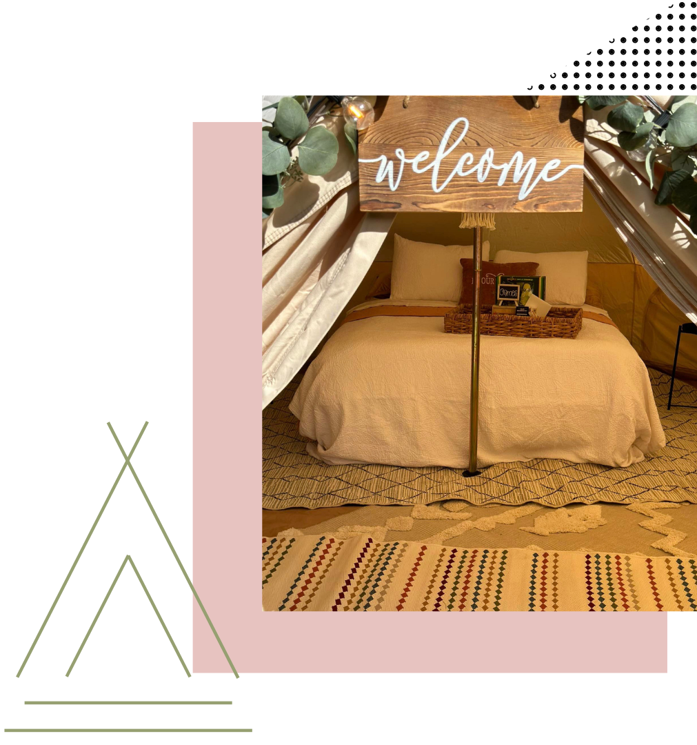 a bedroom with a bed and a welcome sign | large white tents for rent