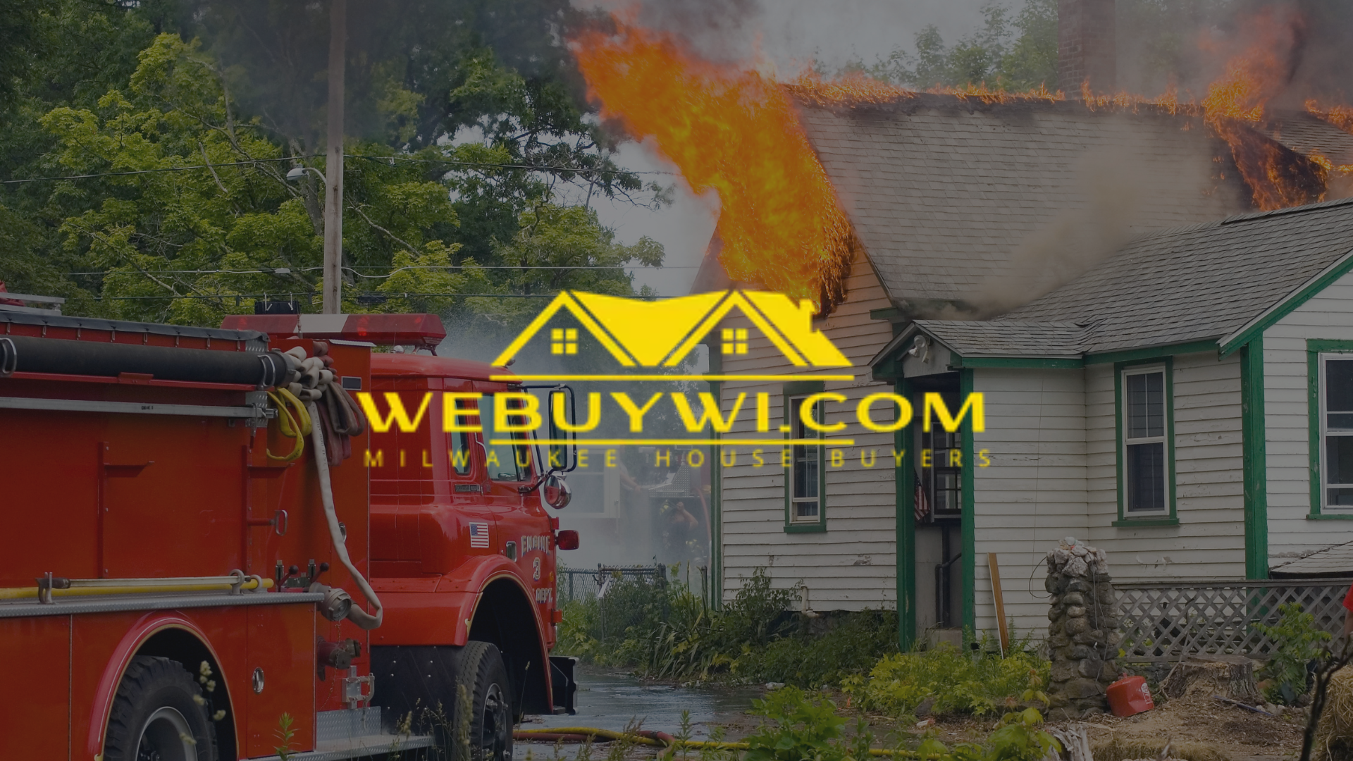 House on fire, firefighters in action, truck nearby.