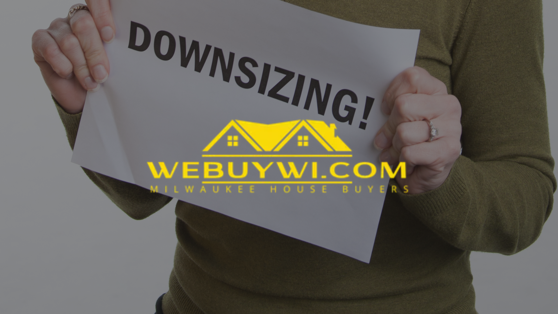 Person holding a sign that says