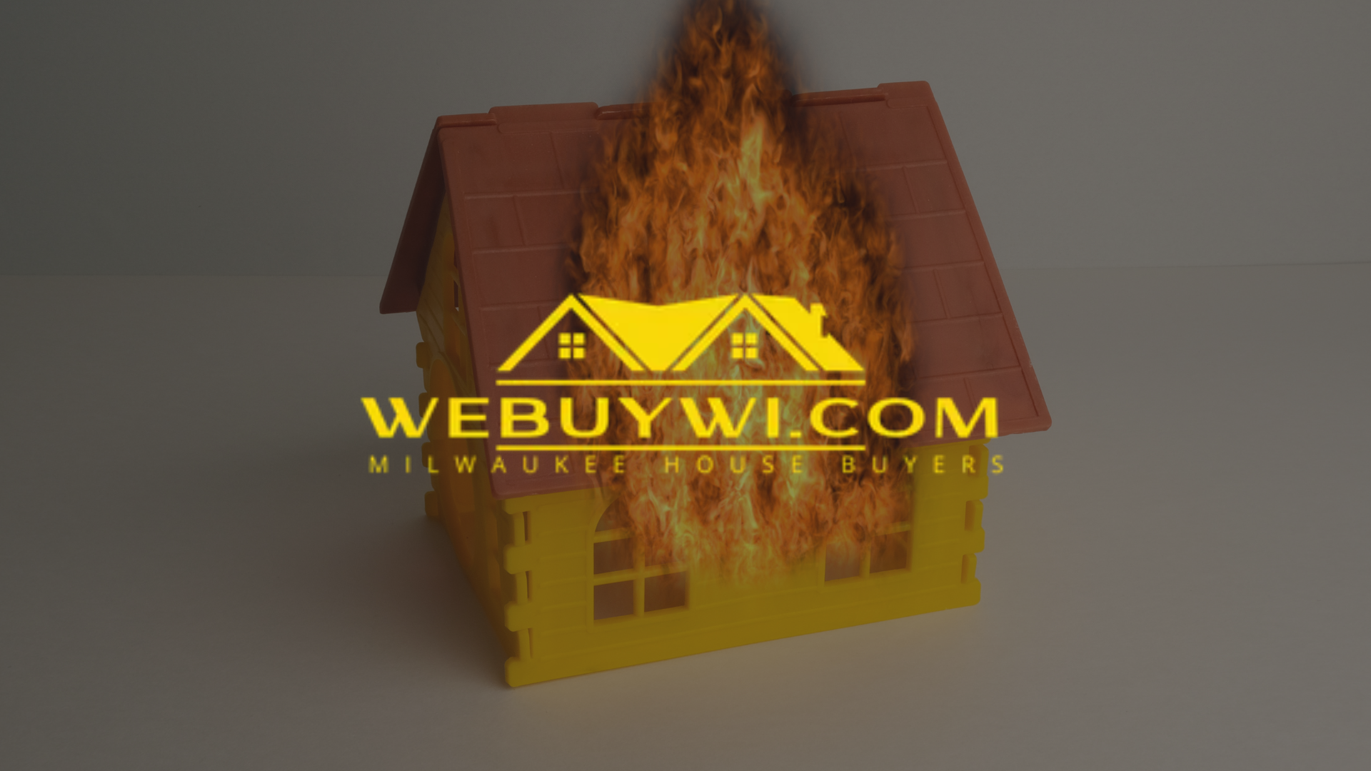 A toy house engulfed in flames with the logo
