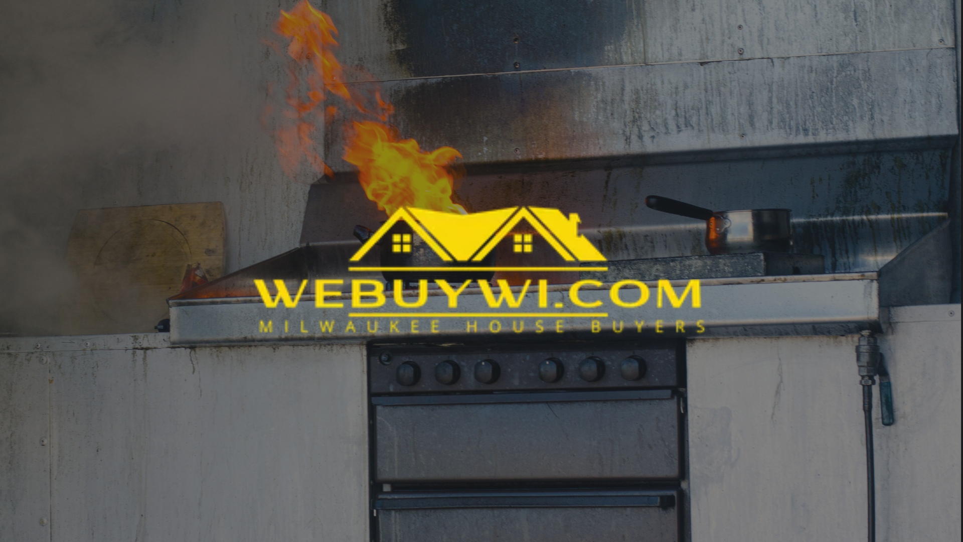 Kitchen fire with flames erupting from a range hood above a black oven, smoke filling the space.