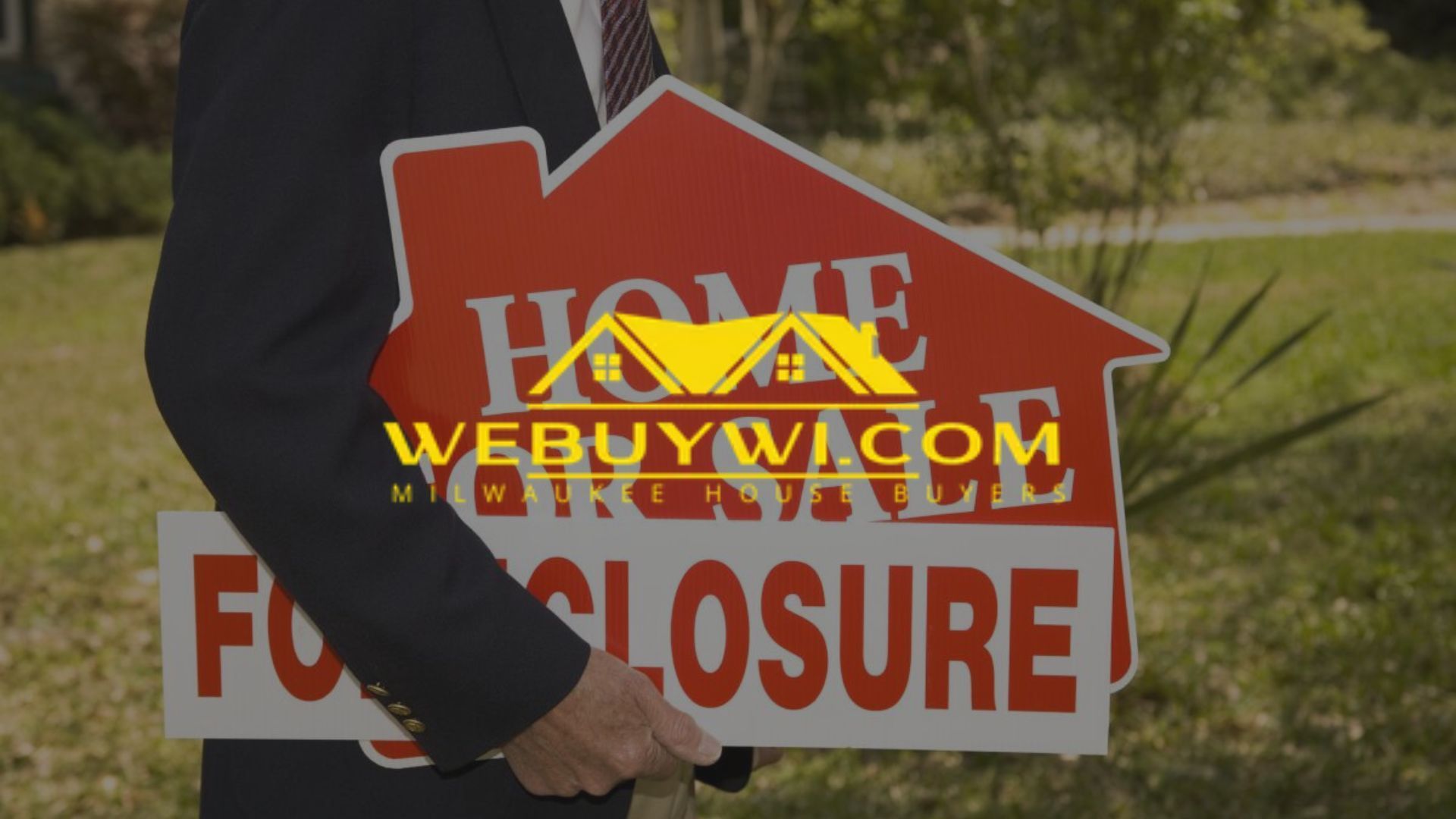Person in suit holding a 
