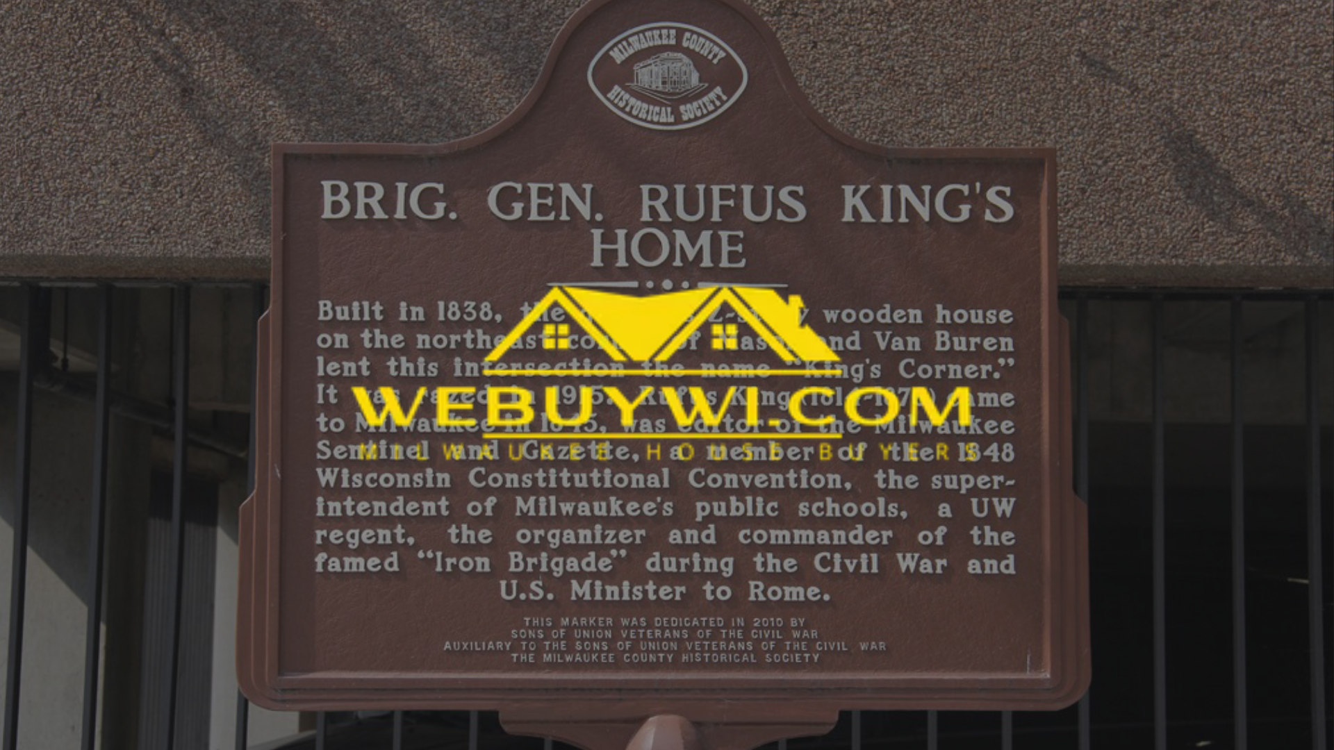 Historical plaque for Brigadier General Rufus King's home. Brown plaque with text on a building.
