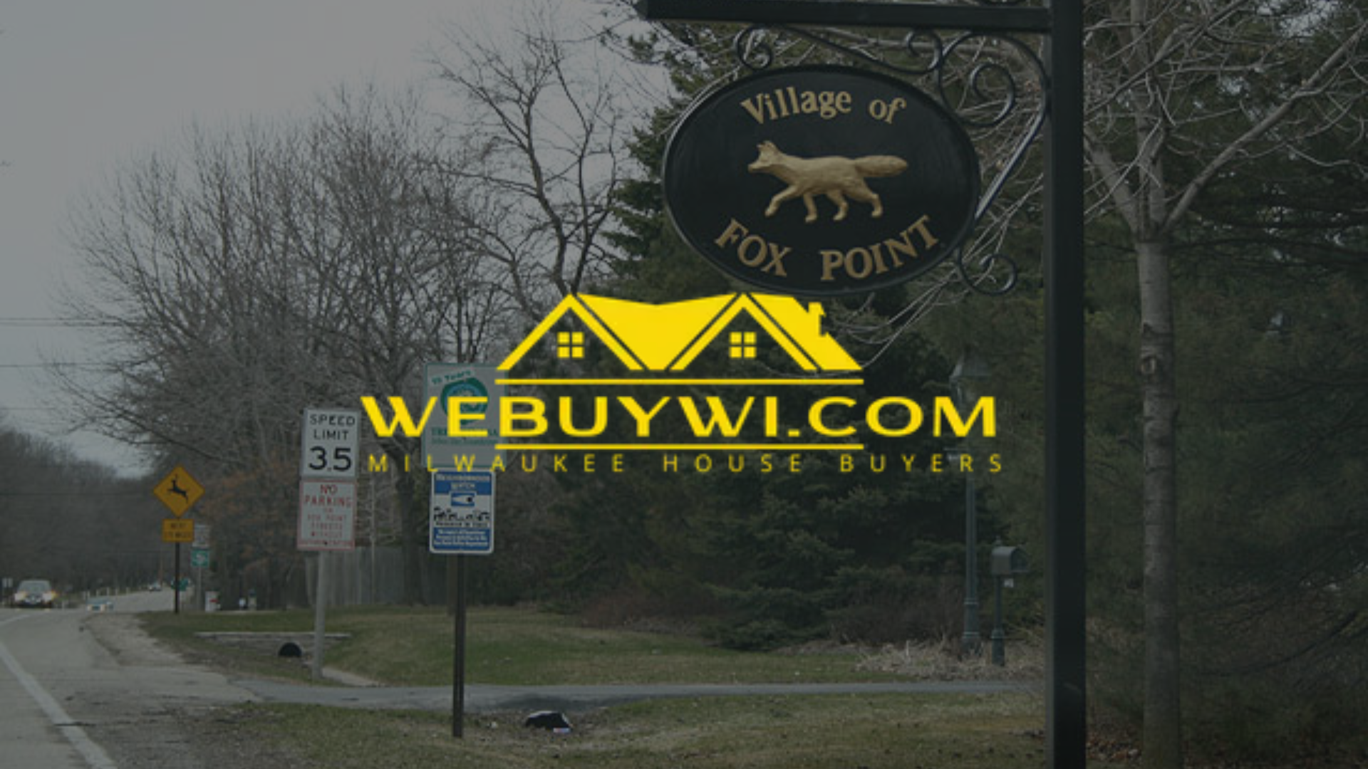 Sign for the Village of Fox Point, WI, with website overlay and road in the background.