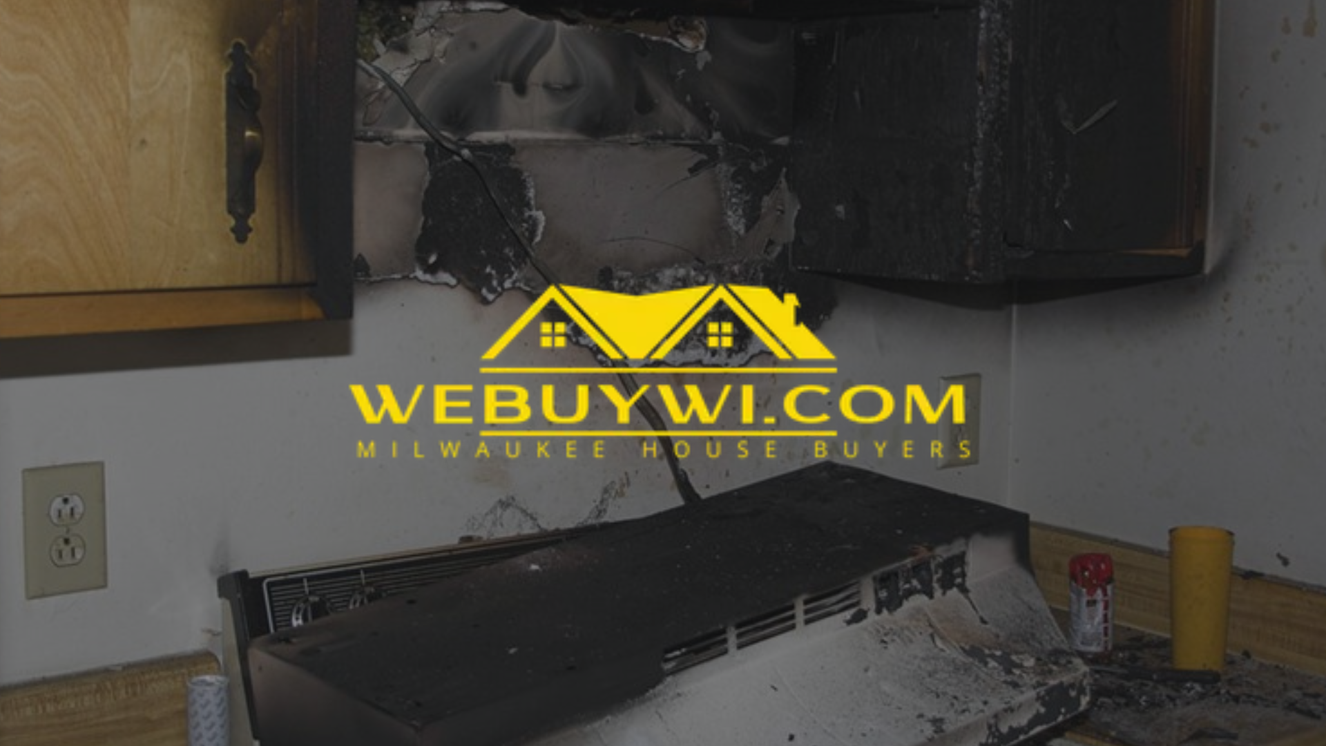 Kitchen cabinet damage from a greenfield wi fire with smoke and char. A “WE BUY WI” logo is overlaid on the scene.