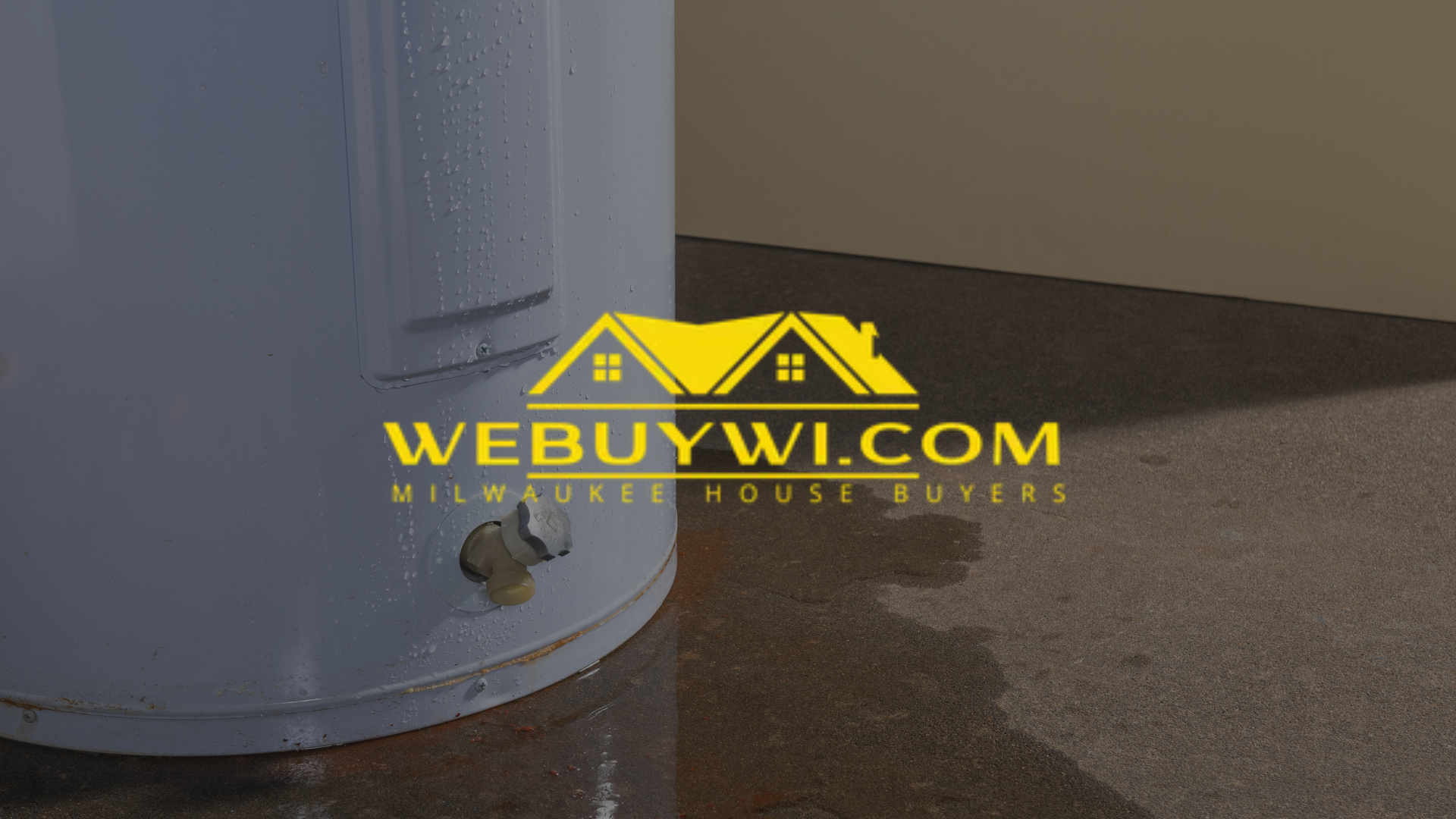 Leaking water heater with a hole near the bottom, on a concrete floor.