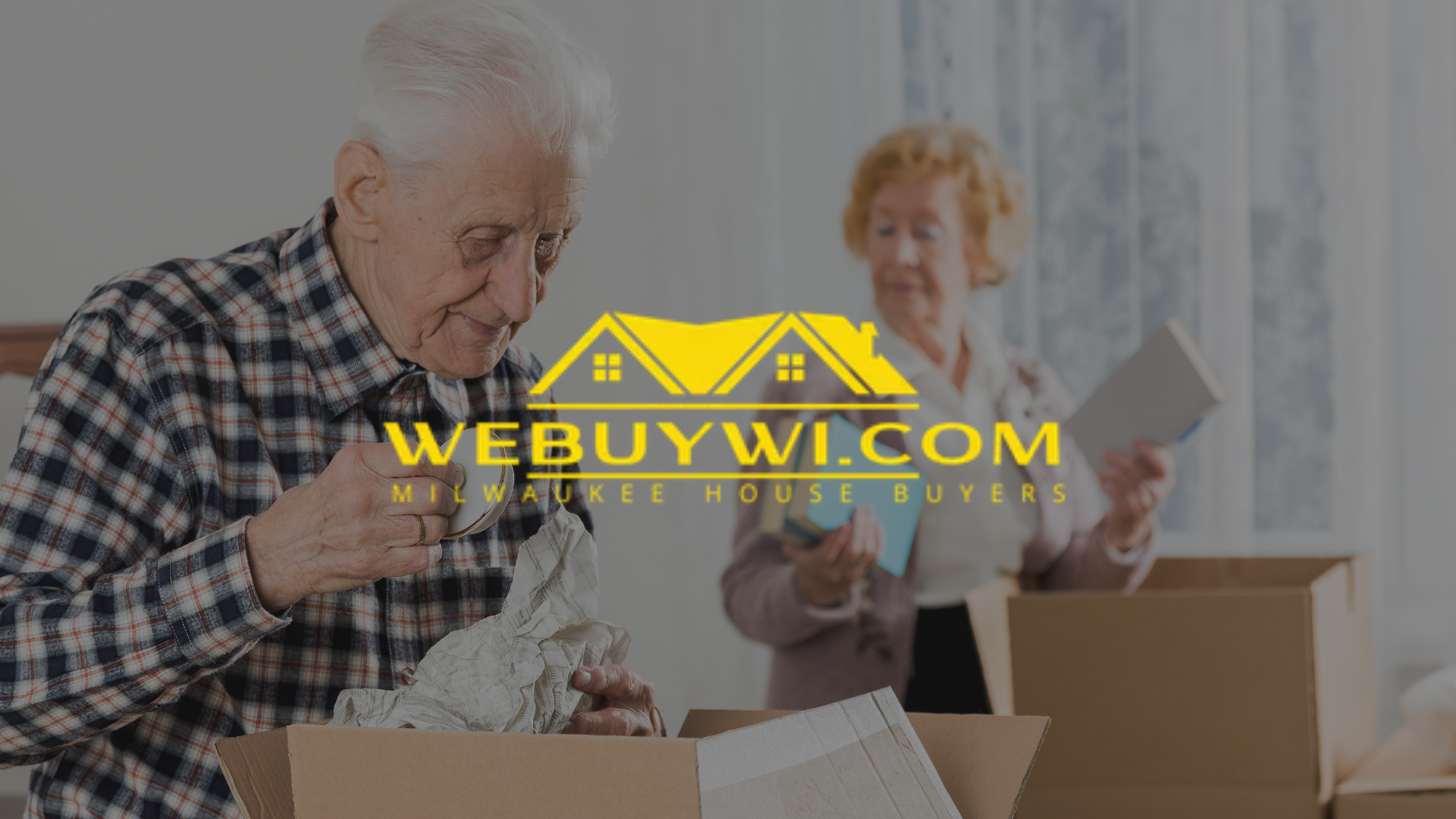An elderly couple packing boxes, potentially preparing to move. The logo