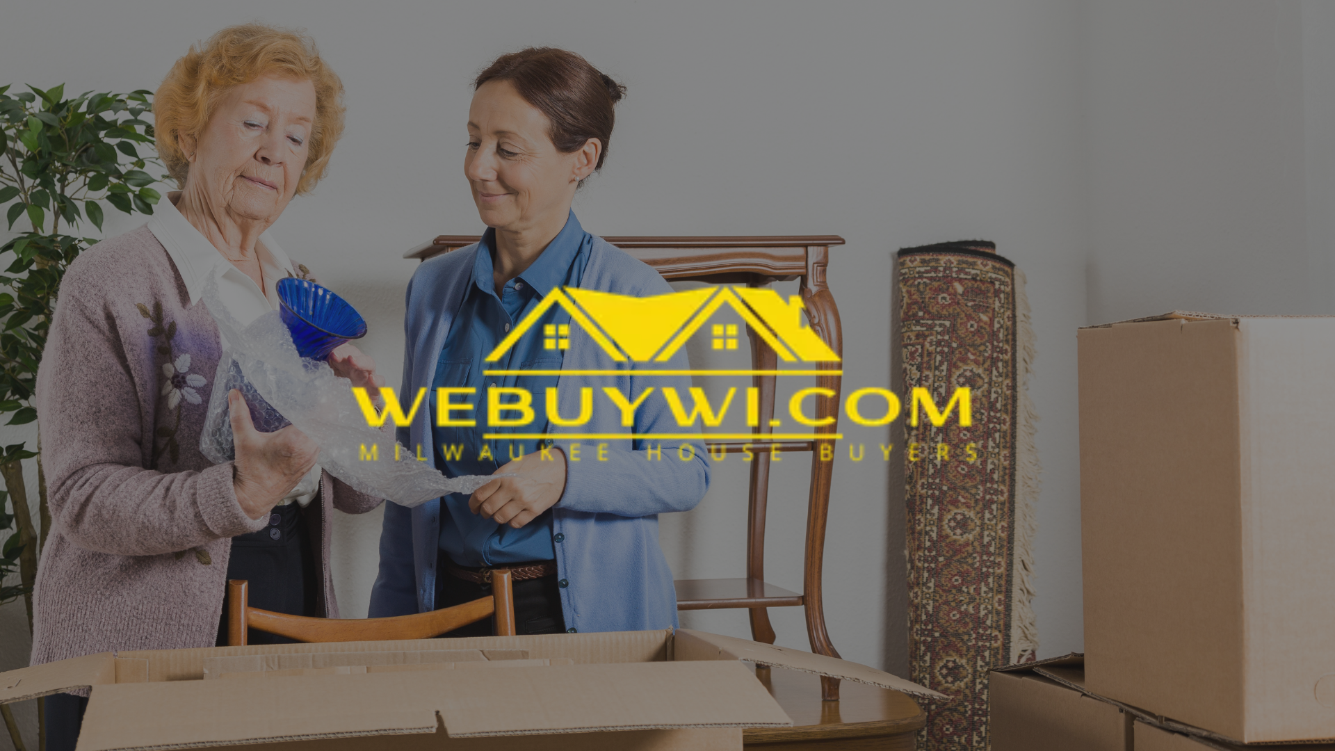 Two women packing boxes, one older, inside a home. A logo for