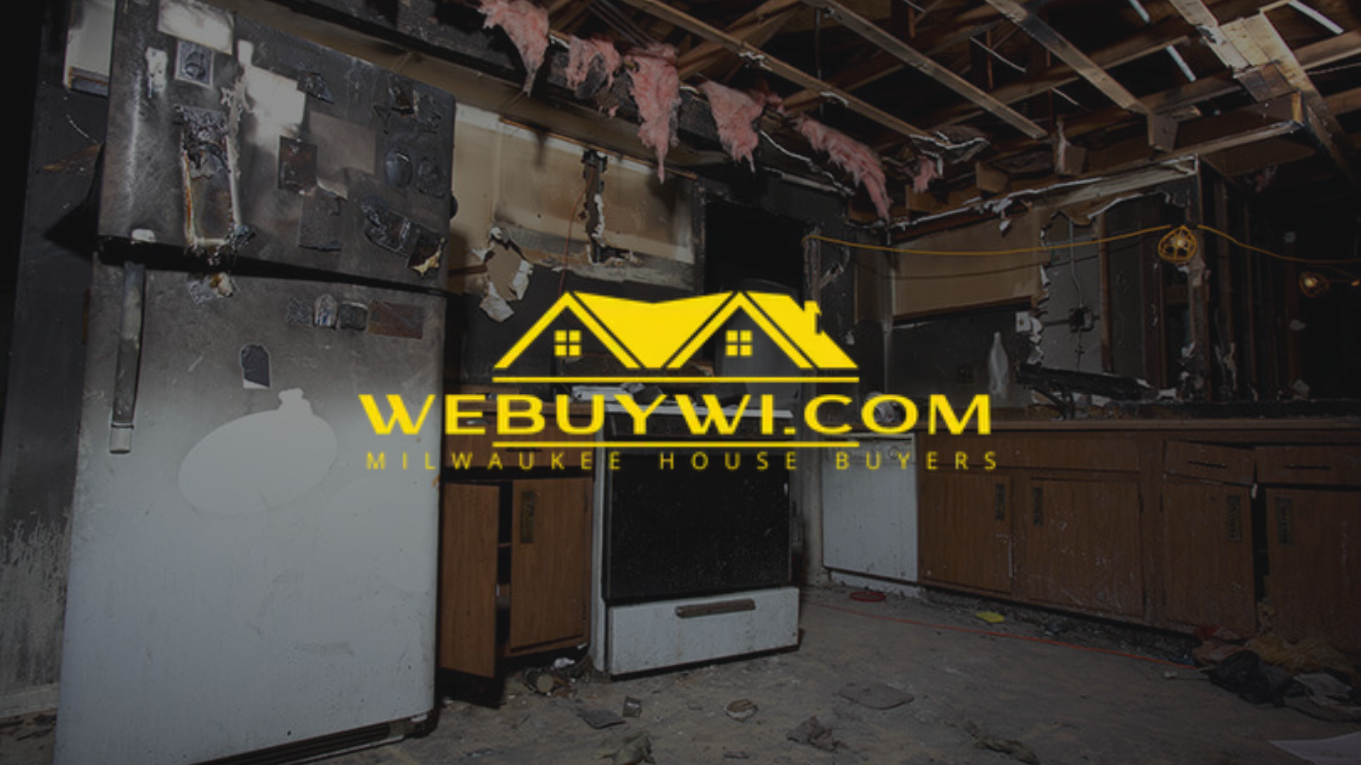 Kitchen after a fire. Burnt cabinets, fridge, oven, and ceiling.