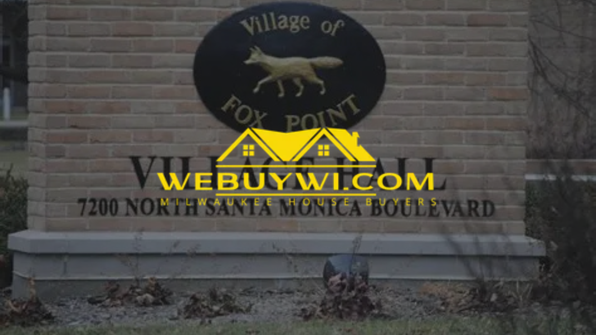 Sign for Village of Fox Point at 7200 North Santa Monica Boulevard. Features a circular emblem with a fox.