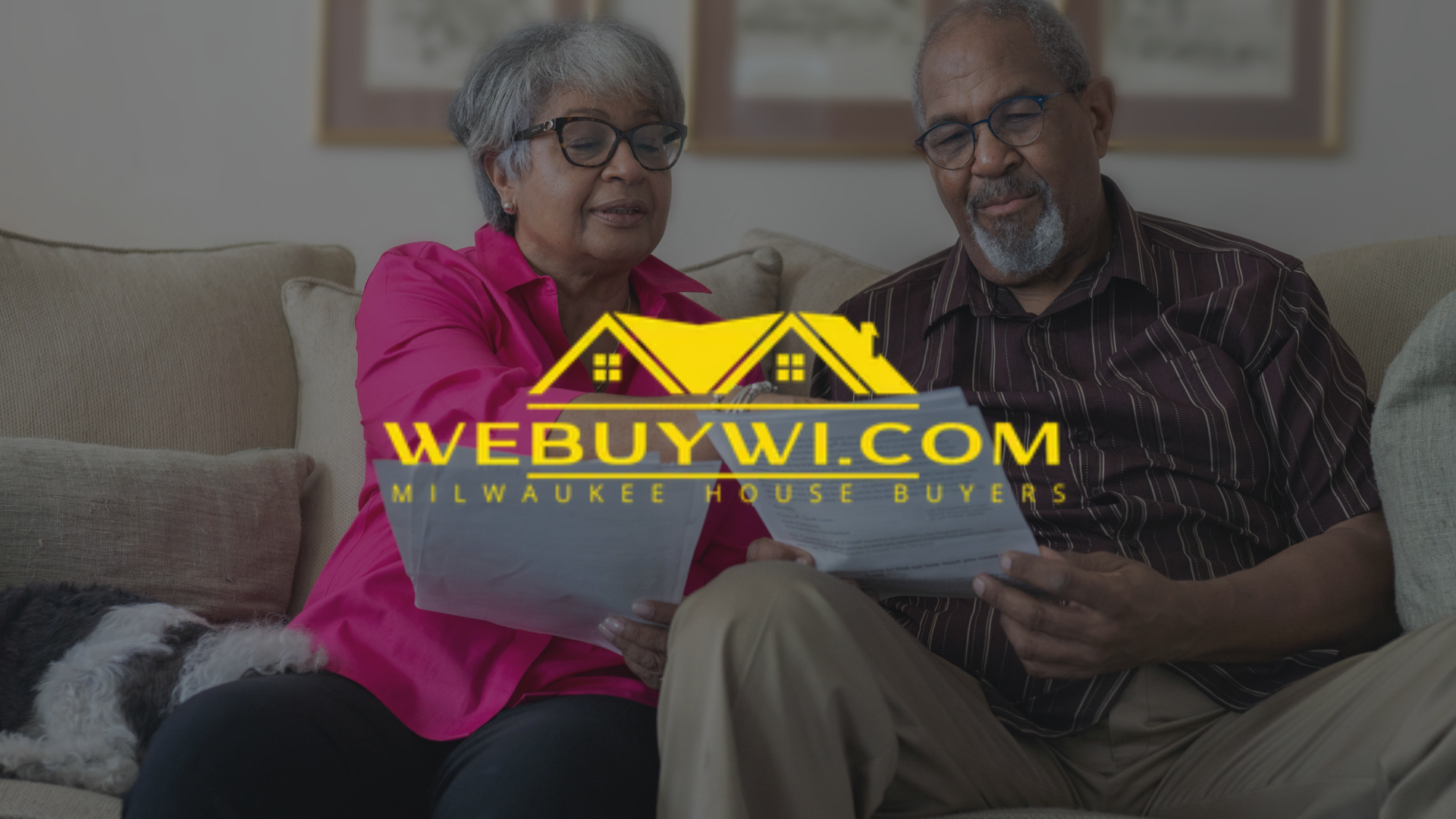 Elderly couple reviewing paperwork on a couch, with a WeBuyWI.com logo overlaid.