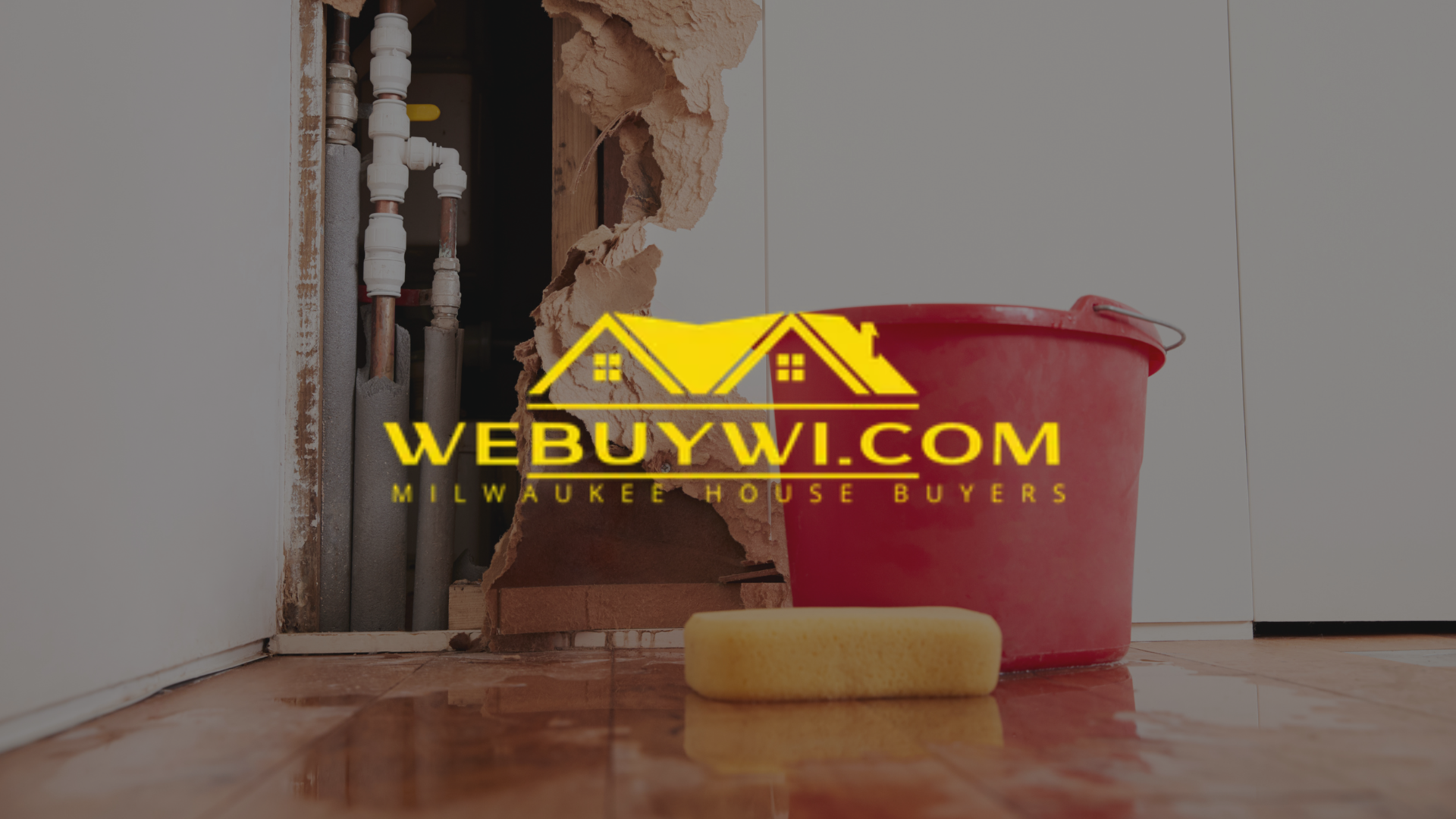 Water damage in a home, with a red bucket and a yellow sponge. The WeBuyWI.com logo is overlaid.