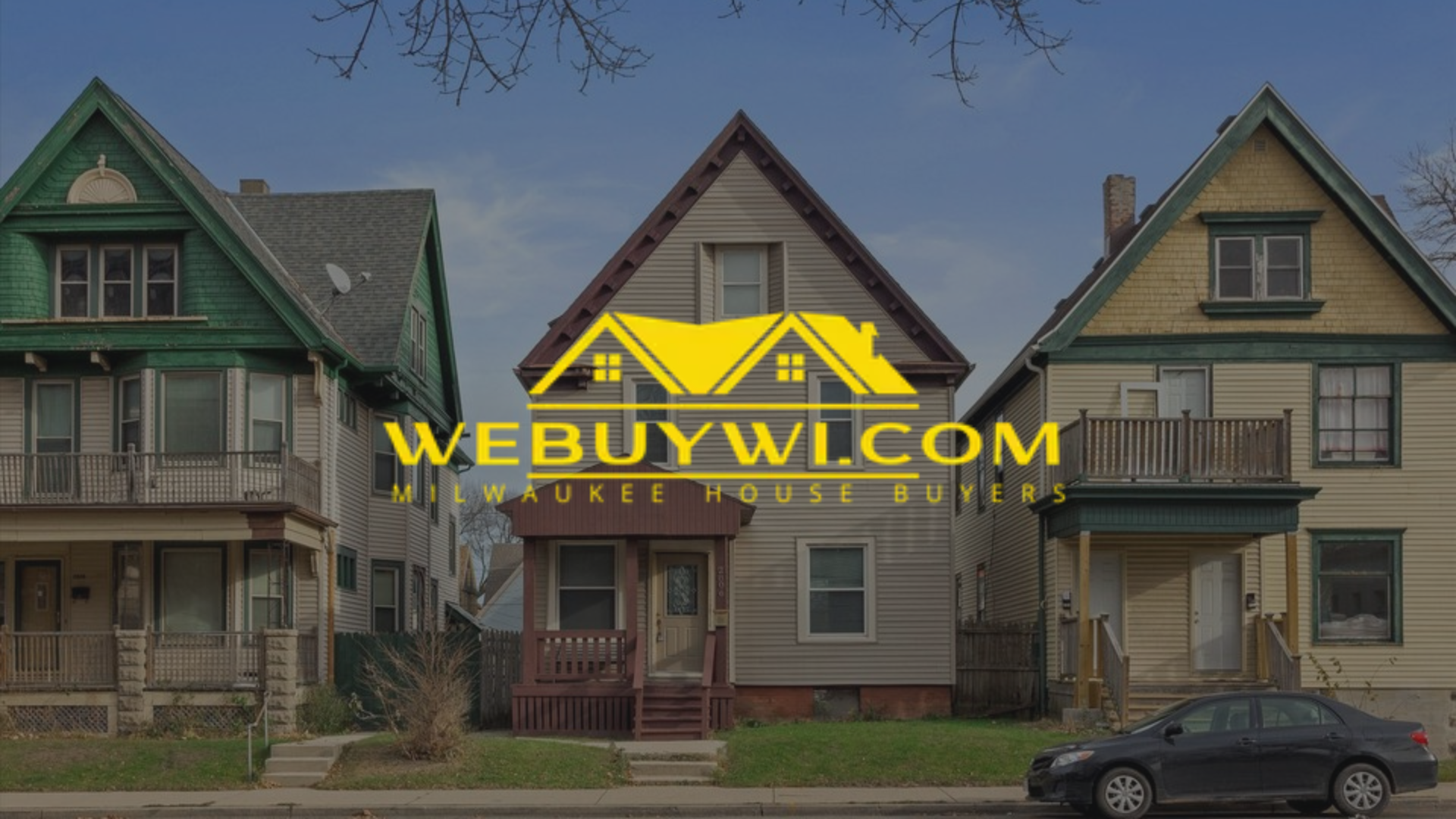 Three houses in a row; a website logo over the middle house says